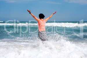 happy woman stands in the sea beach