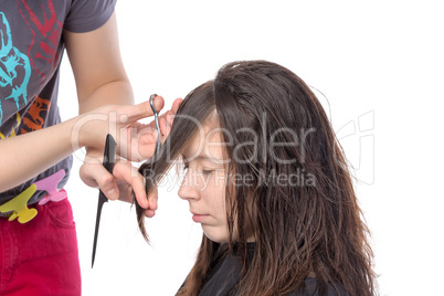 young woman having a hair cut