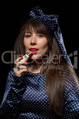 elegant sensual woman applying red lipstick