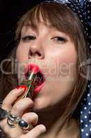 sexy sensual woman applying red lipstick
