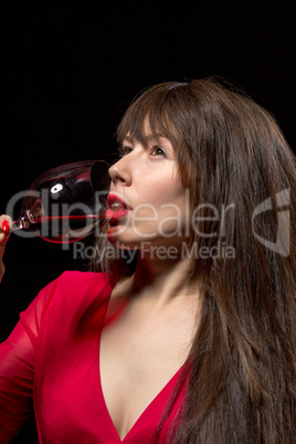 young woman drinking red wine from a glass