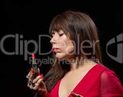elegant sensual woman applying red lipstick
