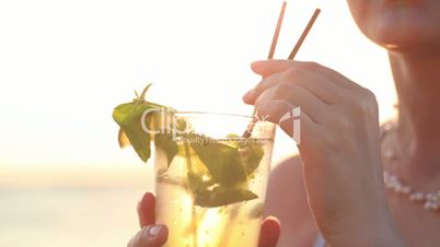 Woman enjoying a mojito cocktail