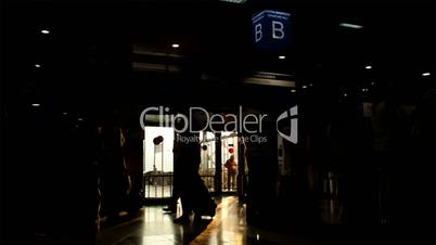 Silhouette of passengers in the airport with bags in the morning