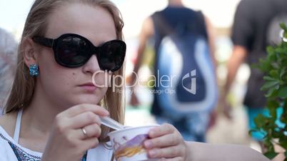 woman eating ice cream in the street cafe