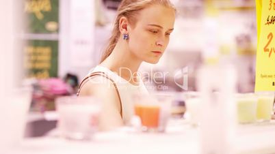 Young woman smelling scented candles