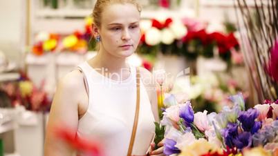 Beautiful young lady buying fresh flowers