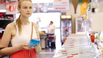 young woman buying products at the supermarket