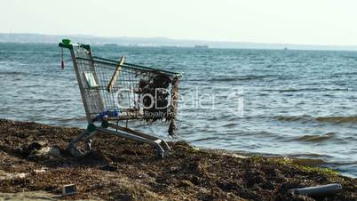 abandoned shopping trolley on the beach