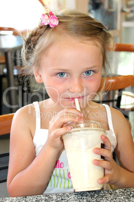 little beautiful girl drinking the cocktail in fastfood