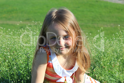 portrait of little girl lying on the grass