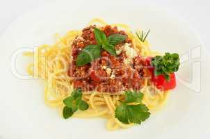 spaghetti bolognese on white plate close up