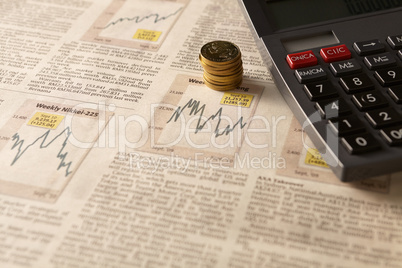 newspaper stock market with calculator and money