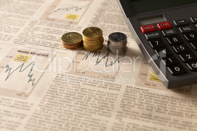 newspaper stock market with calculator and money