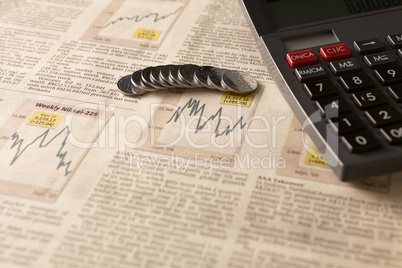 newspaper stock market with calculator and money