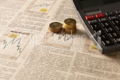 newspaper stock market with calculator and money