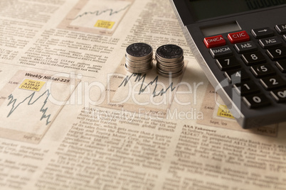 newspaper stock market with calculator and money