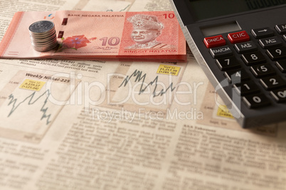 newspaper stock market with calculator and money