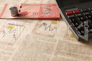 newspaper stock market with calculator and money