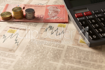 newspaper stock market with calculator and money