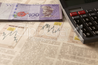 newspaper stock market with calculator and money