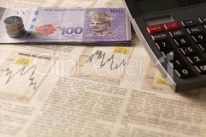 newspaper stock market with calculator and money