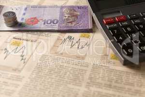 newspaper stock market with calculator and money