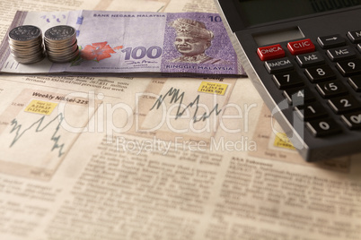 newspaper stock market with calculator and money