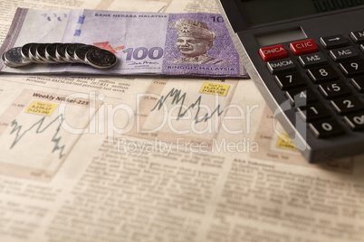 newspaper stock market with calculator and money