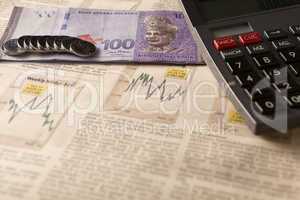 newspaper stock market with calculator and money