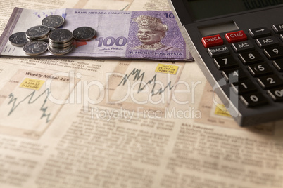 newspaper stock market with calculator and money