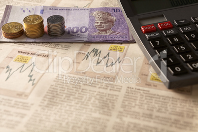 newspaper stock market with calculator and money