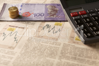 newspaper stock market with calculator and money