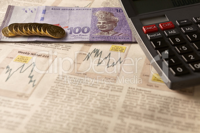 newspaper stock market with calculator and money