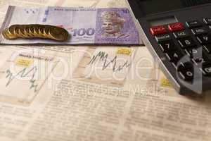 newspaper stock market with calculator and money