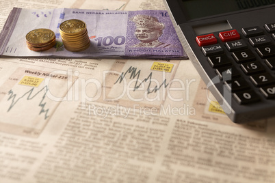 newspaper stock market with calculator and money