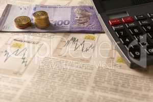 newspaper stock market with calculator and money