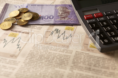 newspaper stock market with calculator and money