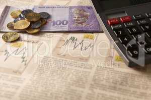 newspaper stock market with calculator and money