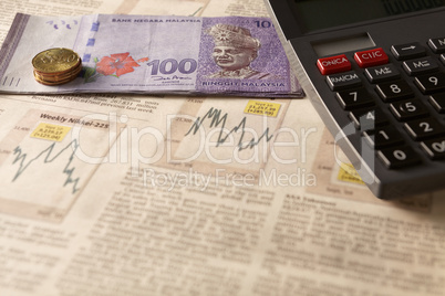 newspaper stock market with calculator and money