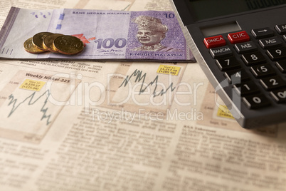 newspaper stock market with calculator and money