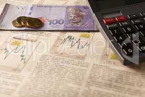 newspaper stock market with calculator and money