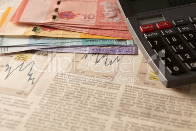 newspaper stock market with calculator and money