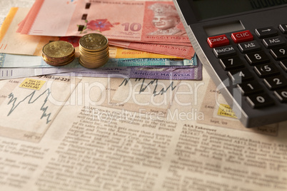 newspaper stock market with calculator and money