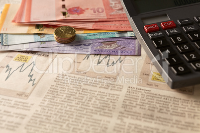 newspaper stock market with calculator and money