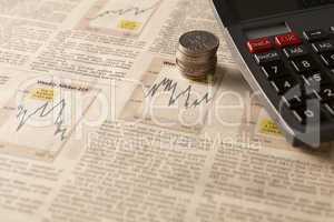 newspaper stock market with calculator and money