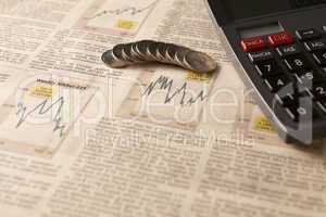 newspaper stock market with calculator and money