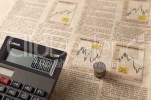 newspaper stock market with calculator and money