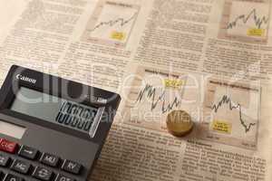 newspaper stock market with calculator and money