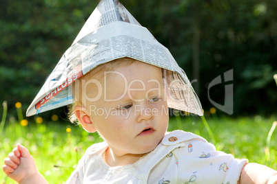 baby with paper on the summer meadow